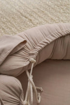Beige baby nest adjustable drawstring, hypoallergenic linen baby lounger detail, CottonNest