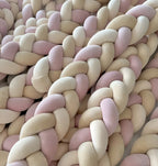 close up 3 strand braided crib bumper pink cream cotton velour texture, multiple bumpers stacked
