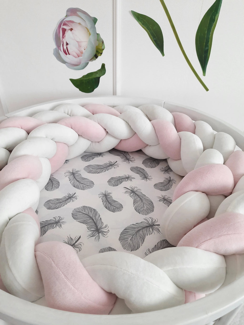 White pink 3-strand braided crib bumper in round white crib with feather print sheet, handmade cotton nursery decor