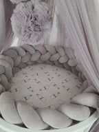 solid gray 4 strand braided crib bumper in round white crib with canopy, gender neutral nursery