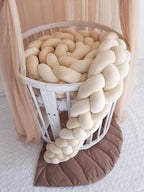 solid ivory 4 strand braided crib bumper coiled in round white crib, boho nursery with canopy
