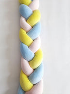 close up 3 strand braided crib bumper yellow blue pink cotton velour texture, handmade baby bumper