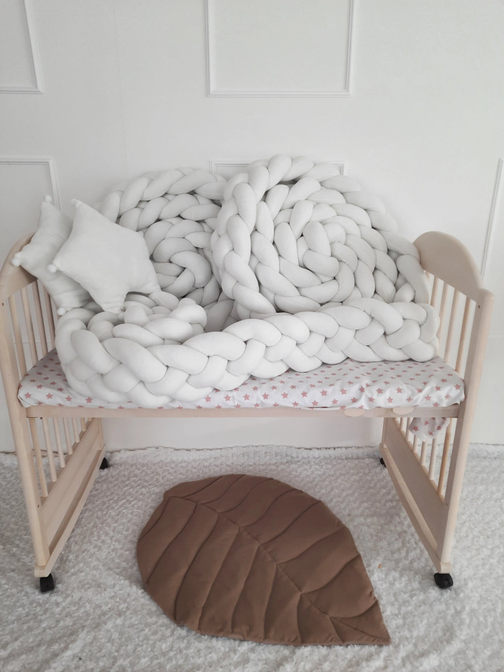 solid ivory 4 strand braided crib bumper coiled in natural wood crib, minimal nursery decor
