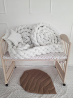 solid ivory 4 strand braided crib bumper coiled in natural wood crib, minimal nursery decor
