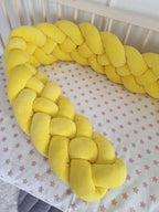 solid yellow 4 strand braided crib bumper in natural wood crib, star print sheet, gender neutral