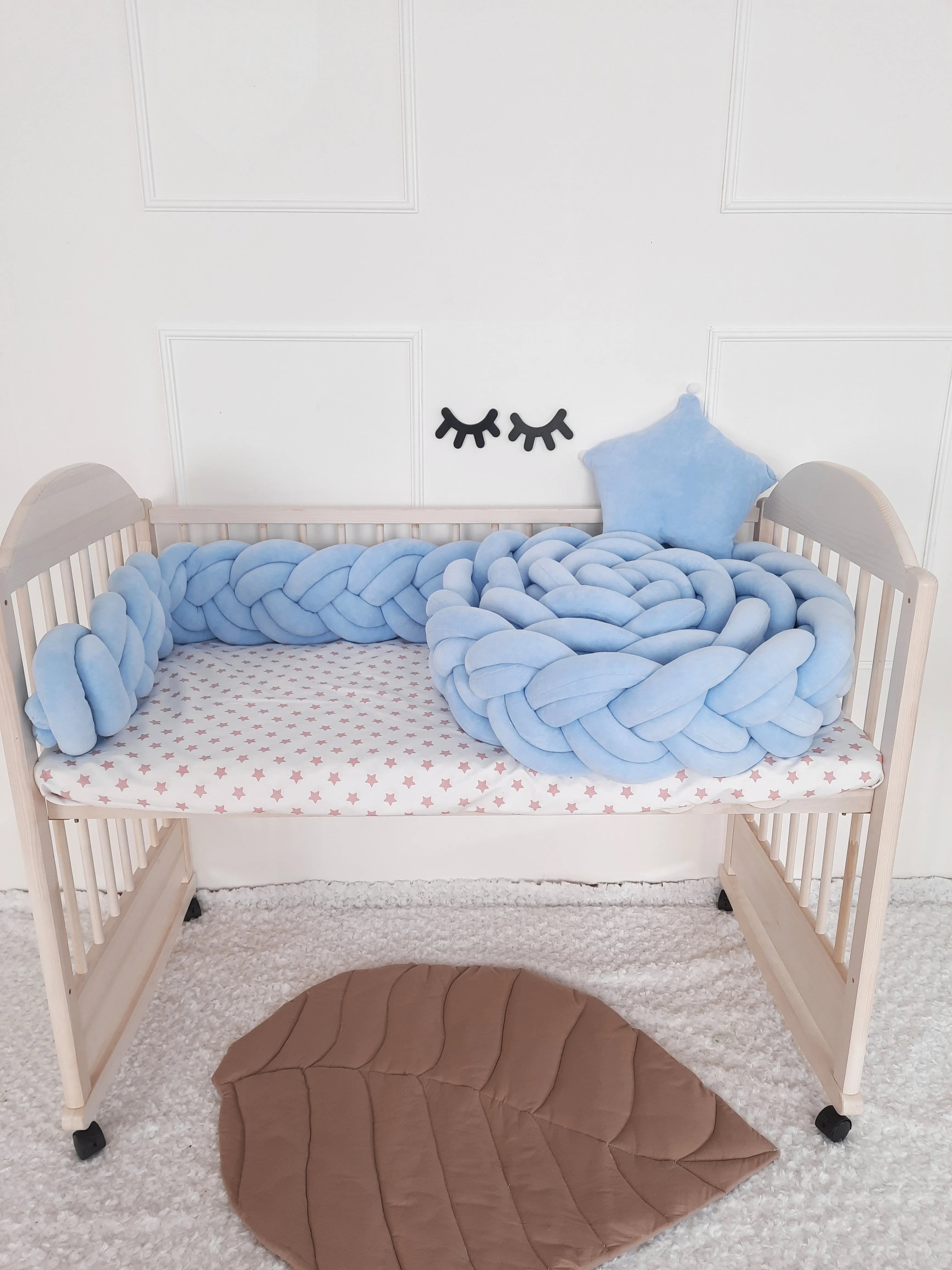 solid light blue double braided crib bumper in natural wood standard crib, star pillow, boy nursery