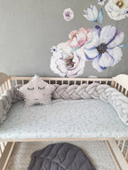 solid light gray double braided crib bumper in natural wood standard crib, star pillow, floral wall nursery