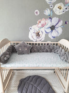 solid gray double braided crib bumper in natural wood standard crib, star pillow, floral wall nursery