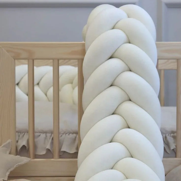 white mermaid braided crib bumper close-up wooden crib cotton velour texture