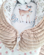 Close-up of plush beige cotton outer on handmade baby nest, soft hypoallergenic newborn lounger detail