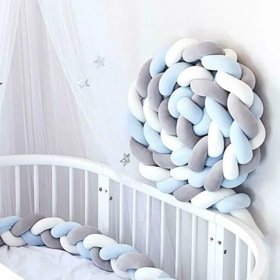 3 strand braided crib bumper gray blue white coiled in white crib corner, nursery canopy