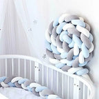 3 strand braided crib bumper gray blue white coiled in white crib corner, nursery canopy