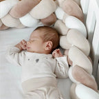 newborn sleeping next to white cream coffee 4 strand braided crib bumper, safe for newborns, OEKO-TEX