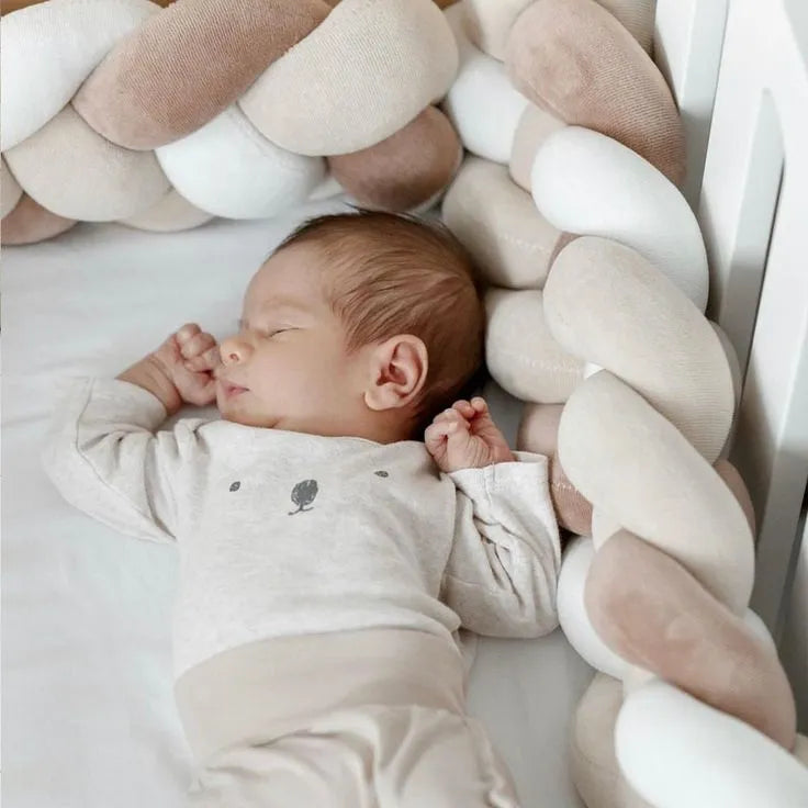 newborn sleeping next to white cream coffee 4 strand braided crib bumper, safe for newborns, OEKO-TEX