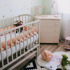 braided crib bumper blush peach in standard crib, baby girl nursery room with dresser