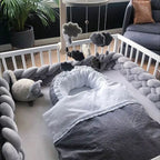 solid cold gray 4 strand braided crib bumper in white standard crib with baby nest, scandi nursery