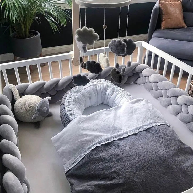 solid cold gray 4 strand braided crib bumper in white standard crib with baby nest, scandi nursery