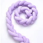 3 strand braided crib bumper solid purple full length coiled on white background, hypoallergenic
